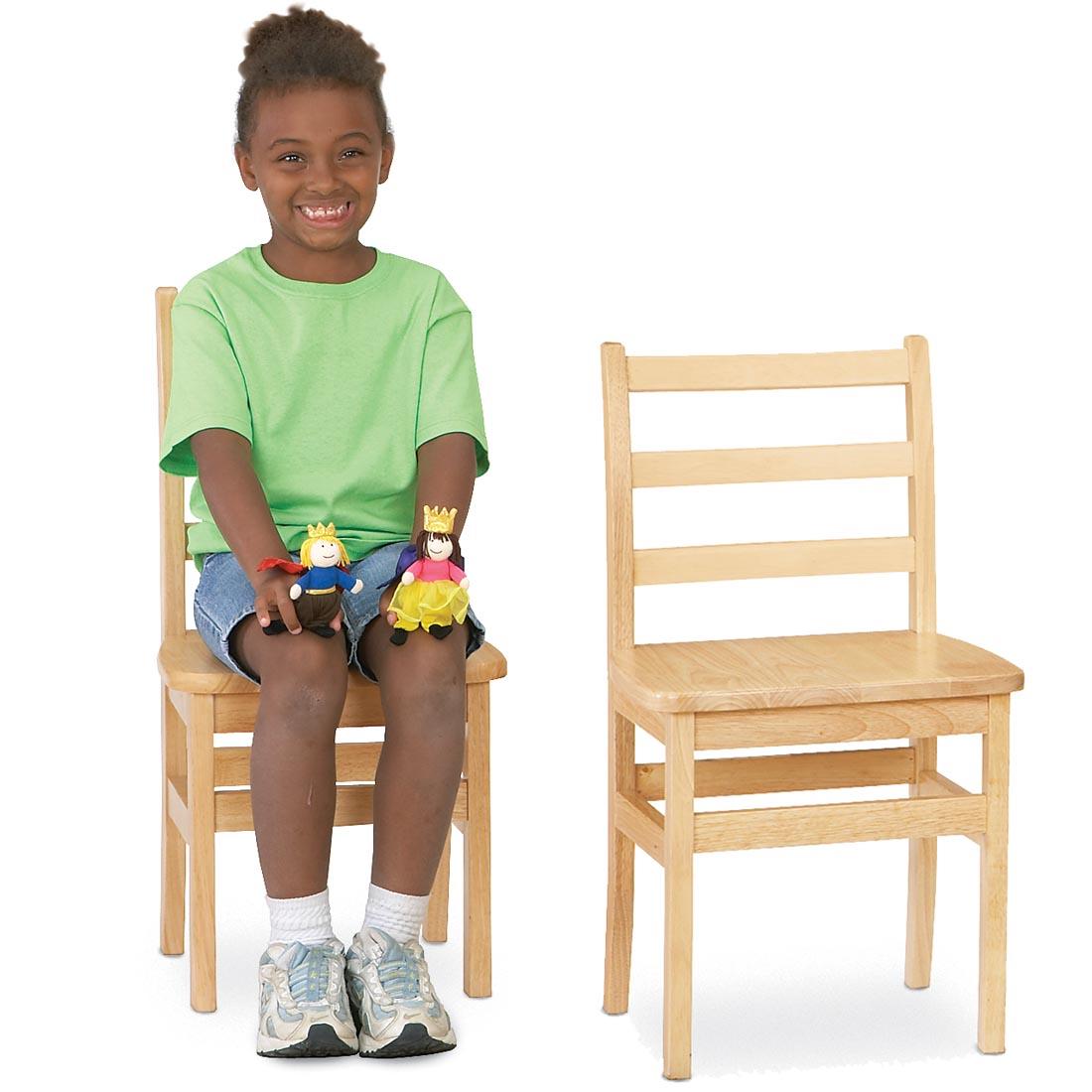 Child sitting on a Ladderback Chair with an empty one beside