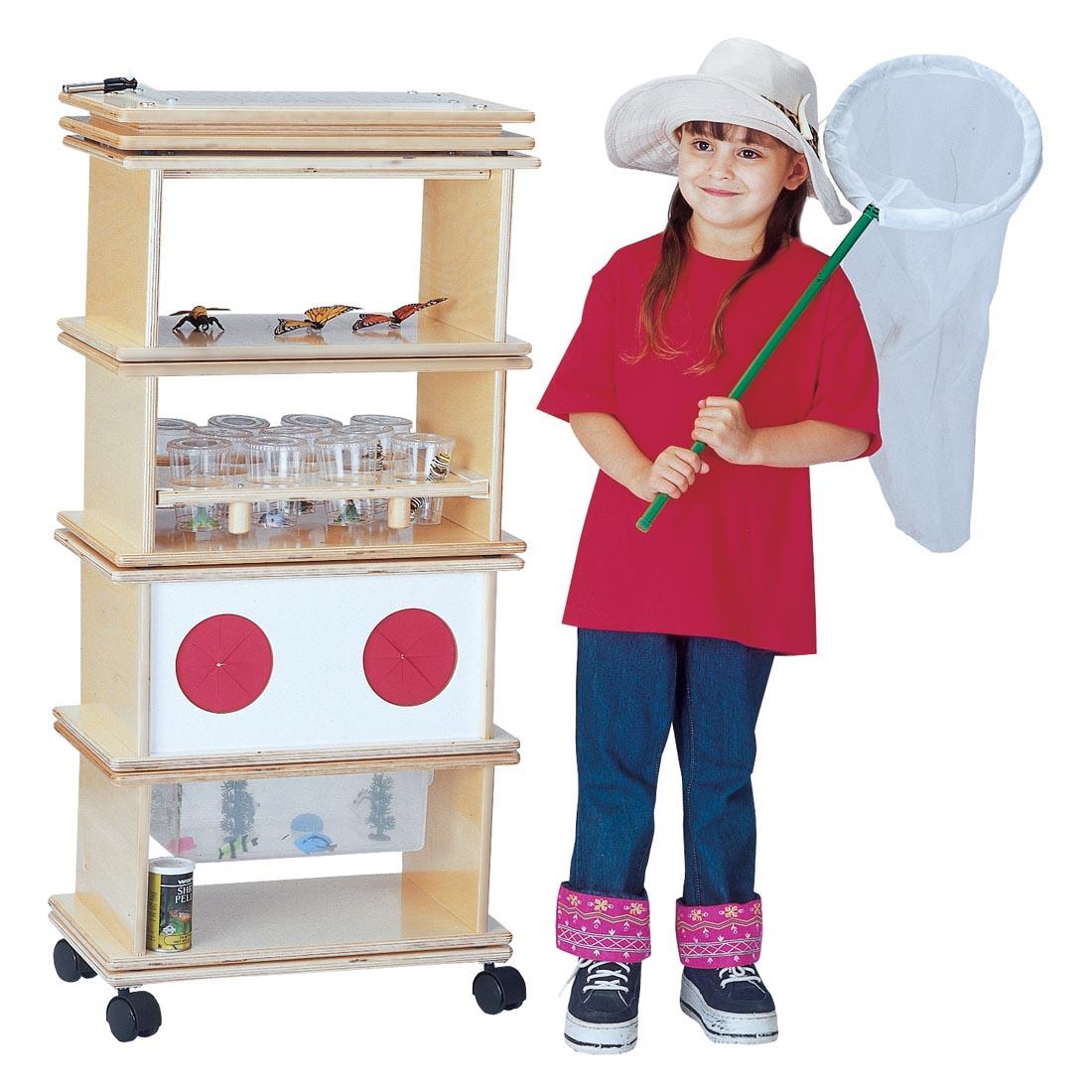 Child with butterfly net standing next to the Science Lab System