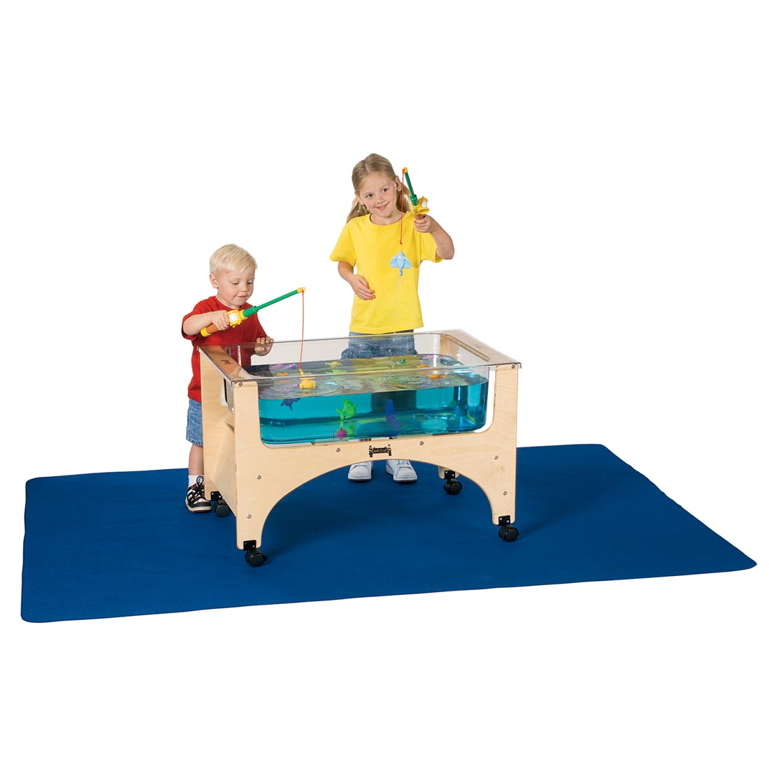 Children "fishing" from a sensory table while standing on the Sensory Table Mat