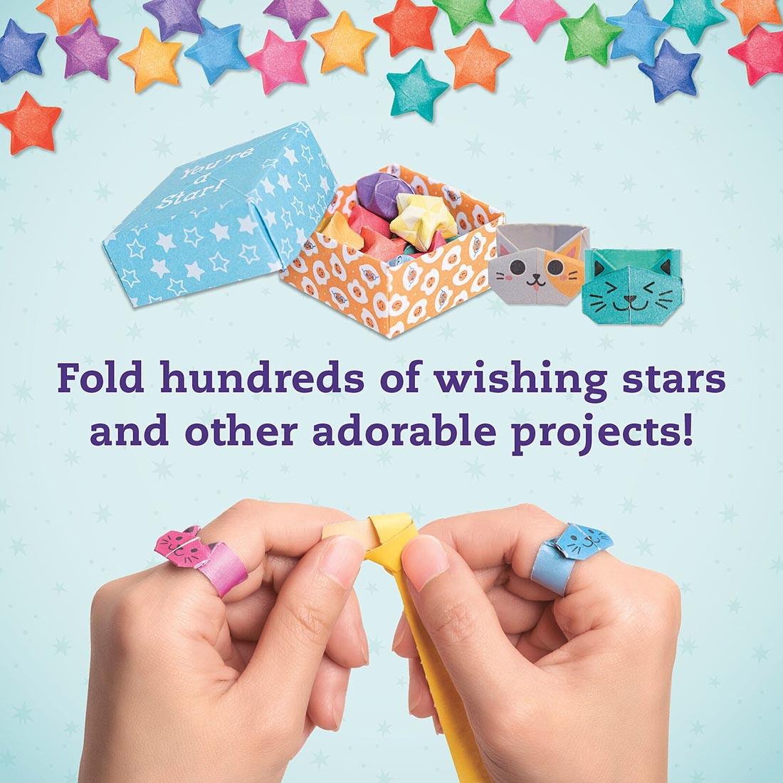 folded boxes from Wishing Stars And Other Super-Cute Origami By Klutz Press plus two hands folding paper and text Fold hundreds of wishing stars and other adorable projects!