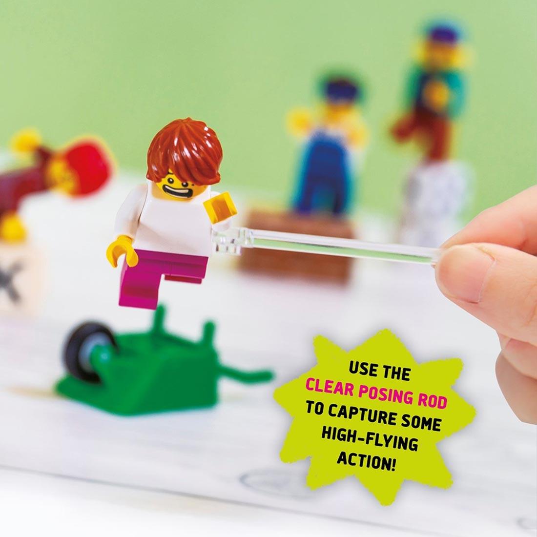 LEGO minifigure scene, with the words, "use the clear posing rod to capture some high-flying action"