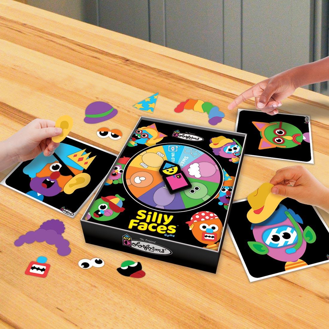 Contents of Colorforms Silly Faces Game shown on a table