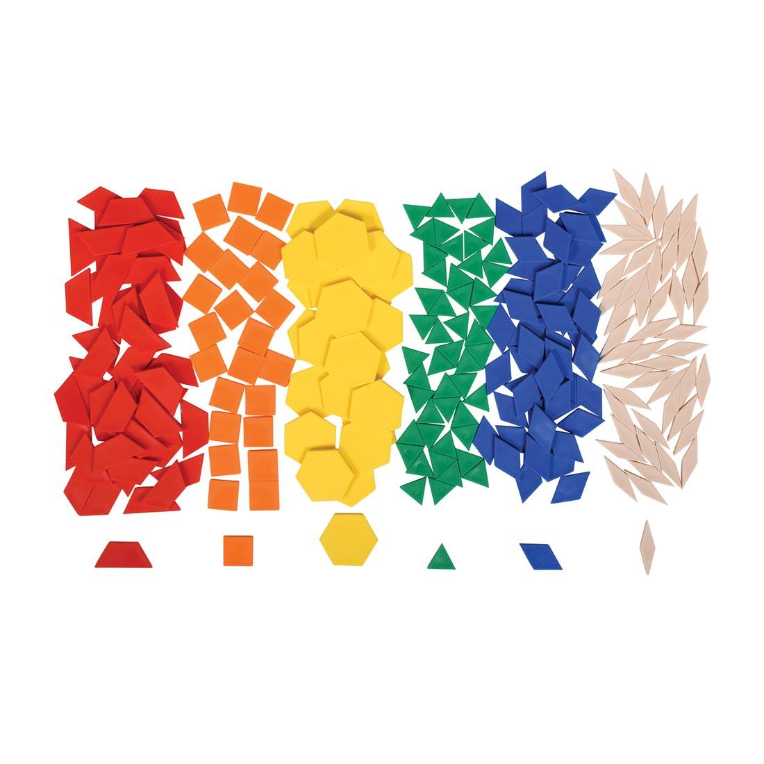 Plastic pattern blocks separated by color, showing 6 different shapes: red trapezoids, orange squares, yellow hexagons, green triangles, blue parallelograms and tan rhombuses