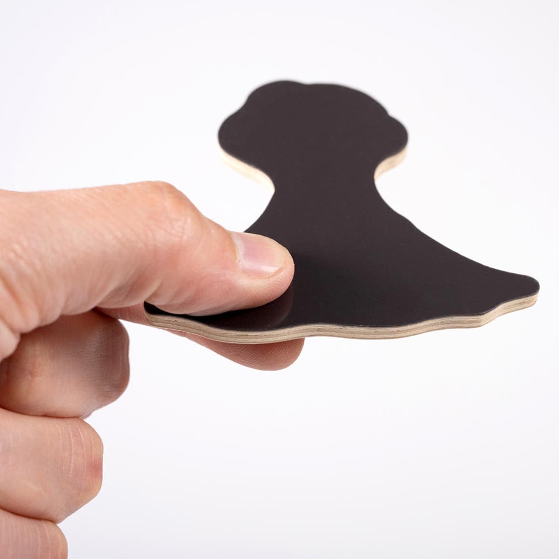 hand holding up the magnet side of a Dinosaur Wooden Magnet
