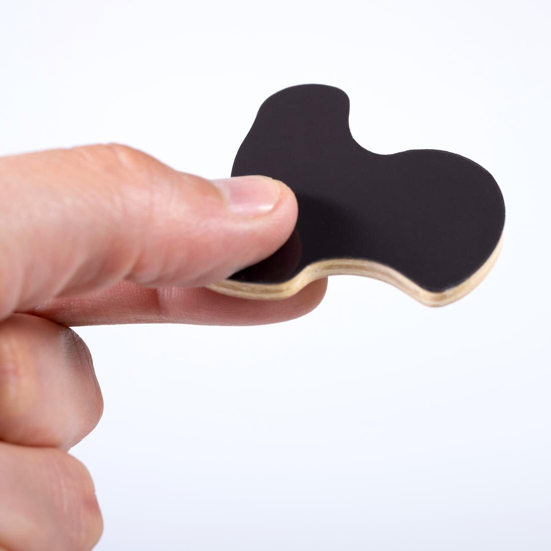 hand holding a Farm Wooden Magnet By Learning Advantage with back side showing