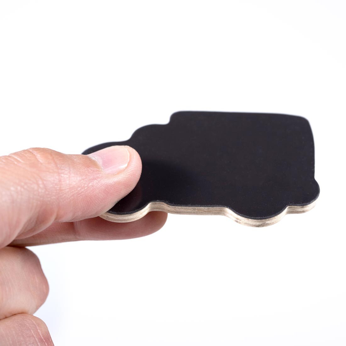 hand holding up the magnet side of a piece from the Transport Wooden Magnets set