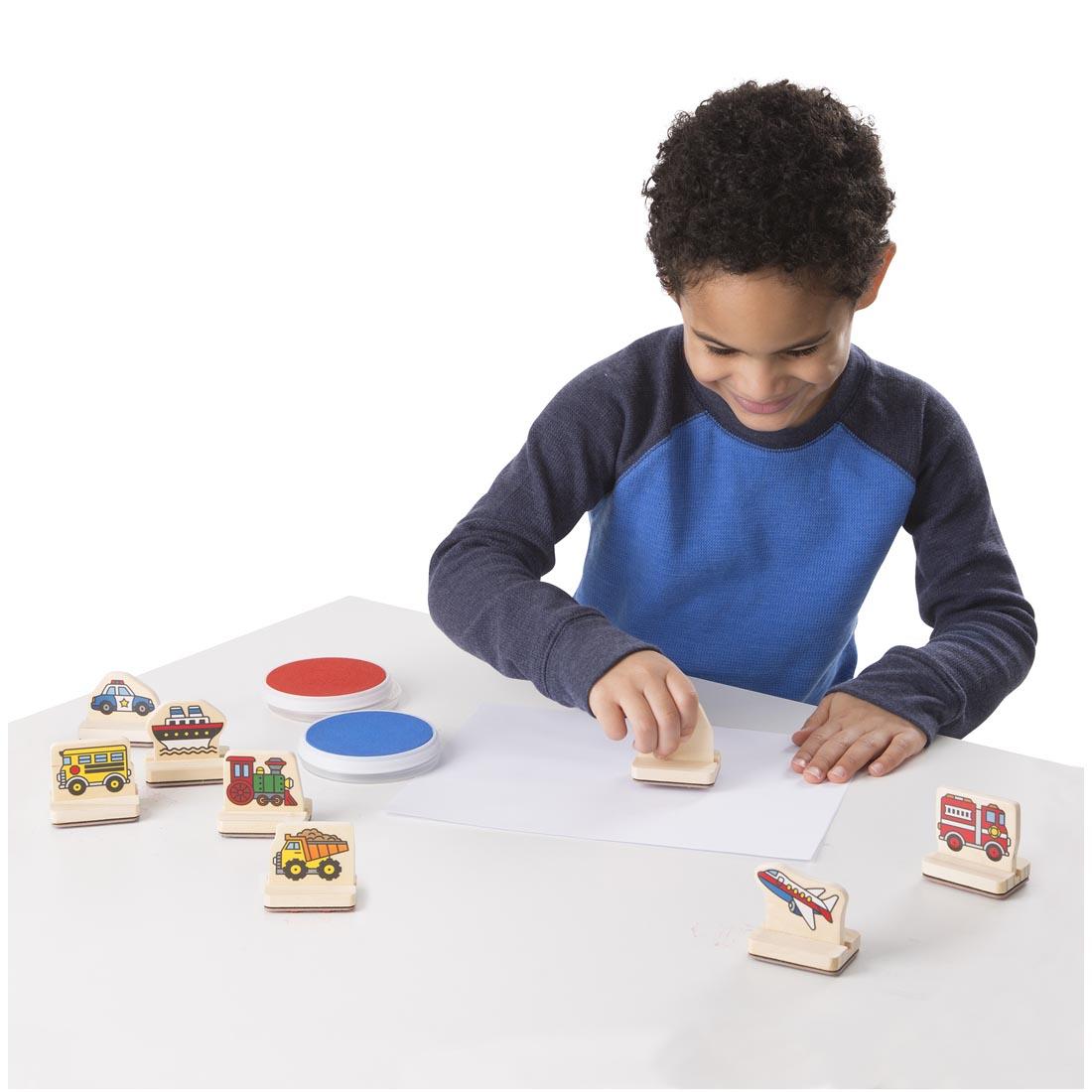 Child using the Melissa & Doug Vehicles My First Wooden Stamp Set