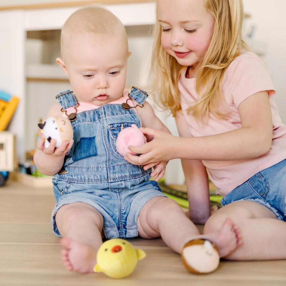 Two children playing with Rollables Farm Friends By Melissa & Doug