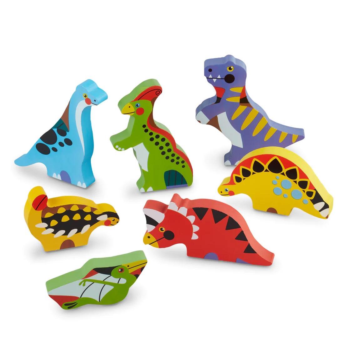 Seven dinosaur figures from the Dinosaurs 7-Piece Chunky Puzzle By Melissa & Doug