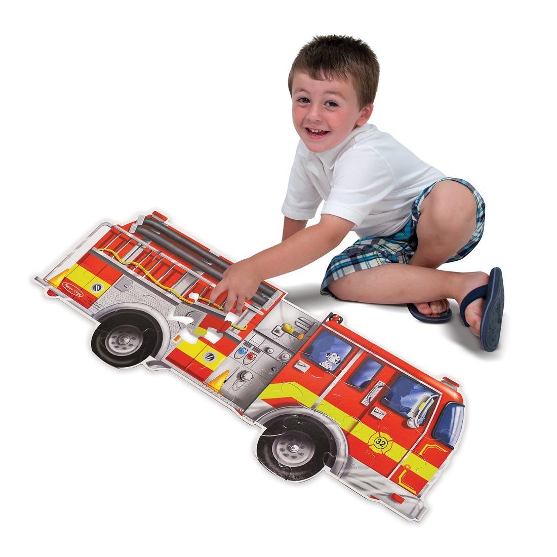 Child completing the Giant Fire Truck Floor Puzzle