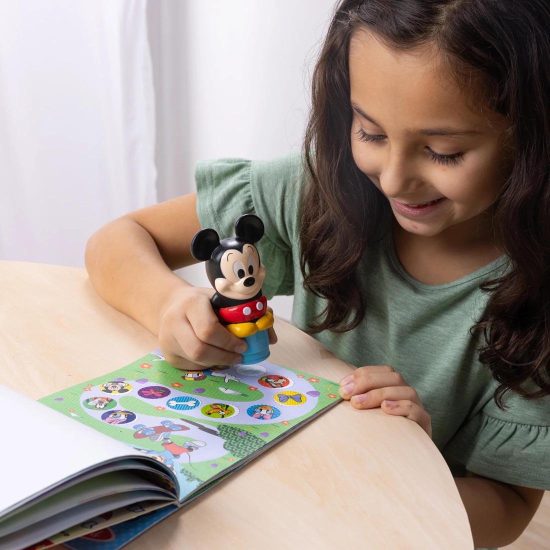 child using the Mickey Mouse Sticker Wow! Set By Melissa & Doug
