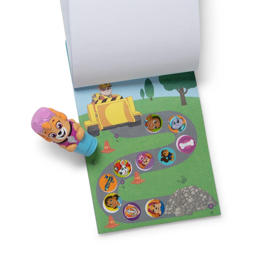 Paw Patrol Skye Sticker Wow! stamper, plus open activity book with several round stickers applied