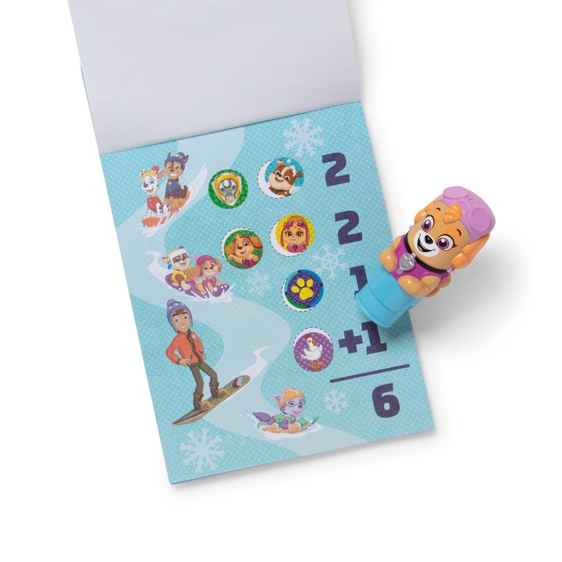 Paw Patrol Skye Sticker Wow! stamper, plus open activity book with several round stickers applied