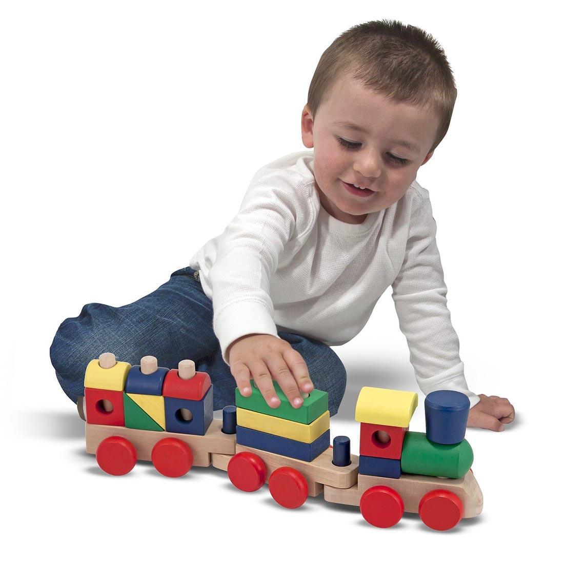 child playing with the Wooden Stacking Train