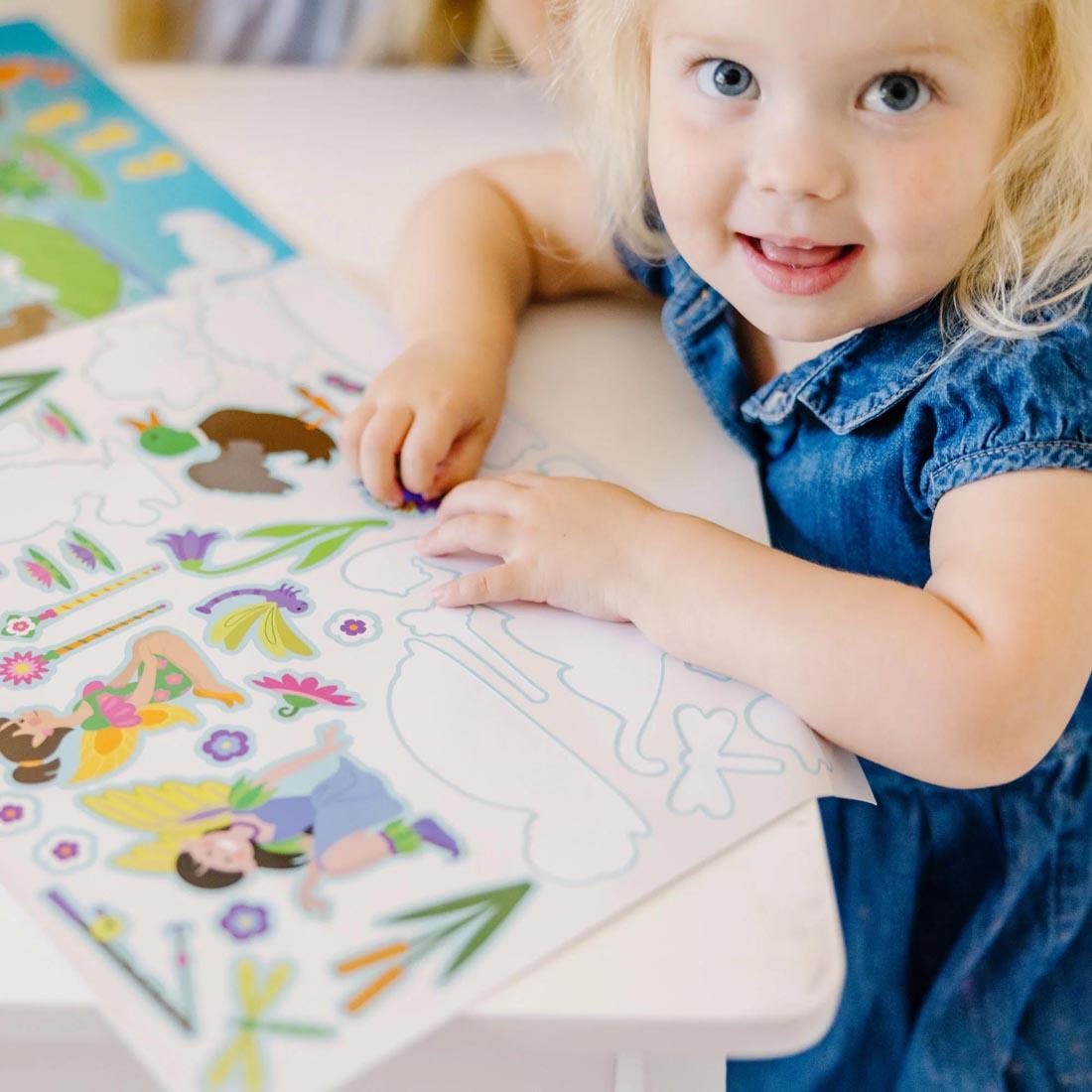 child playing with the Fairies Reusable Sticker Pad By Melissa & Doug