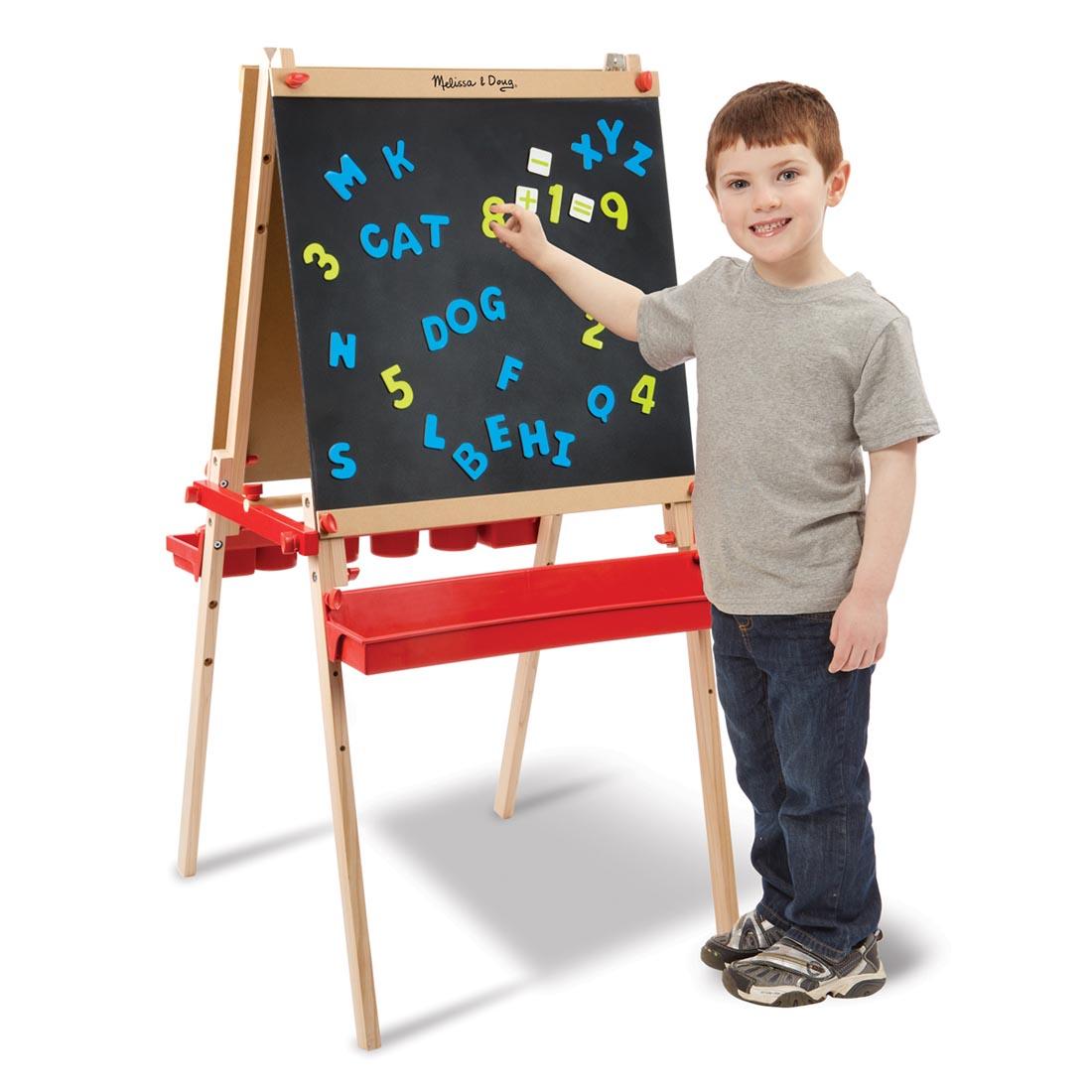 child standing in front of the Deluxe Magnetic Standing Art Easel