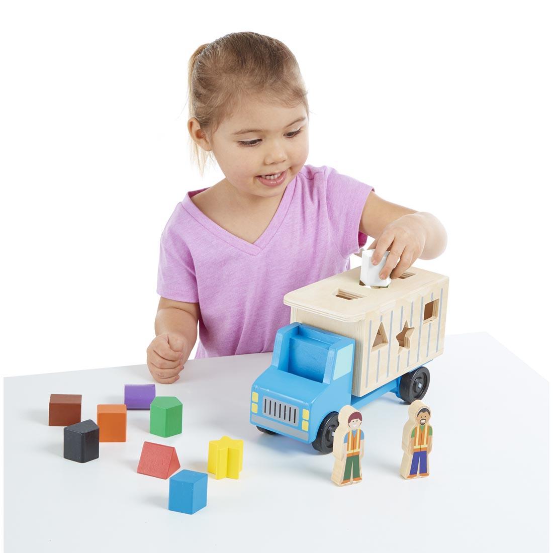 child playing with the Shape Sorting Dump Truck