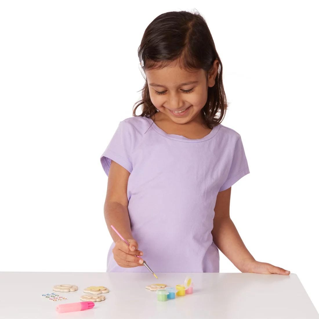 child using the Created by Me! Flower Magnets Wooden Craft Kit By Melissa & Doug