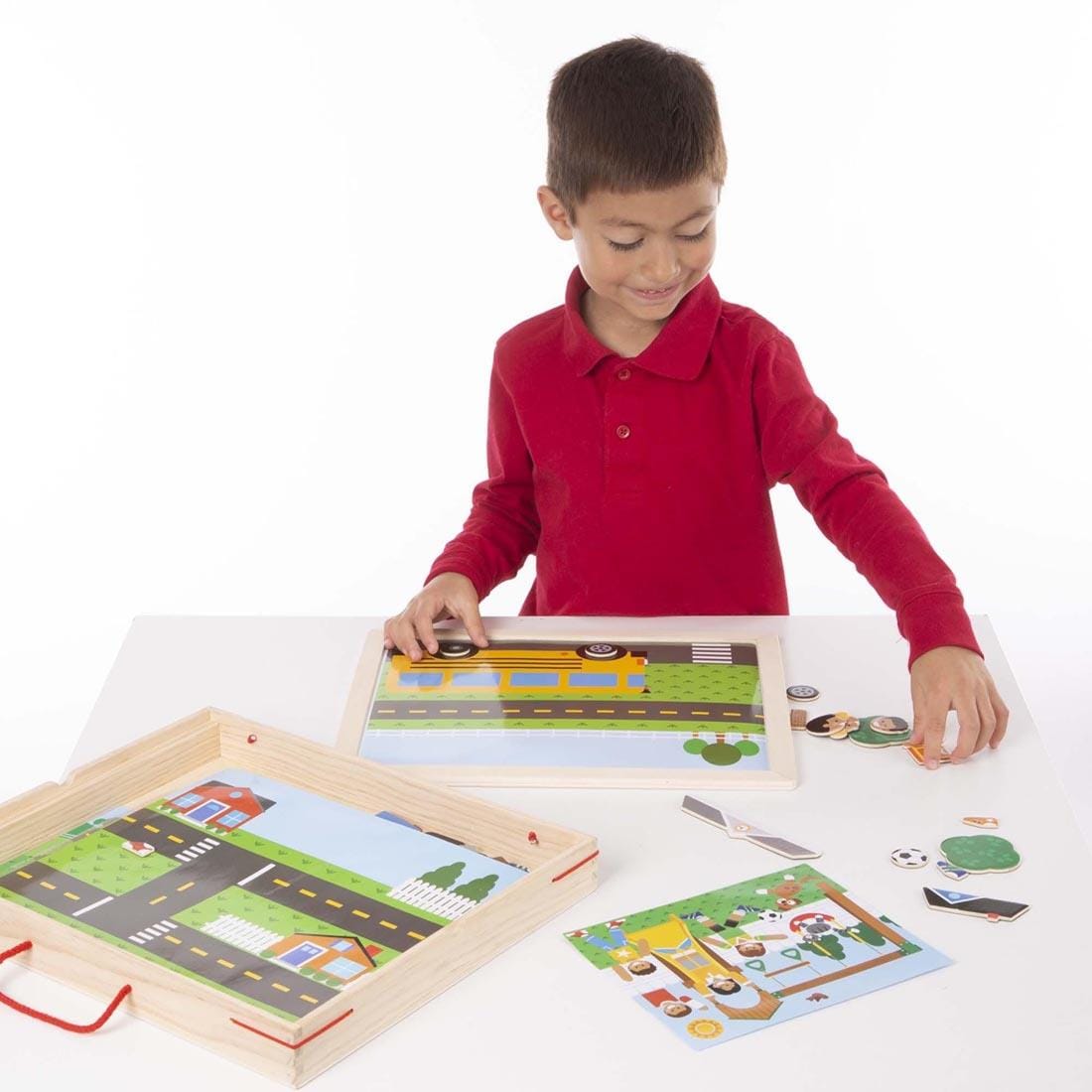 child playing the Wooden Magnetic Matching Picture Game By Melissa & Doug