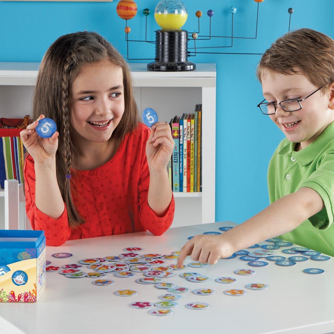 2 kids playing the I Sea 10! Math Game By Learning Resources