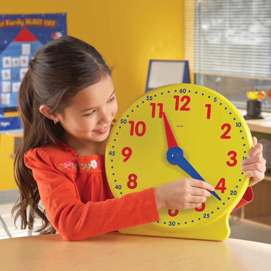 child using the Big Time Demonstration Clock By Learning Resources