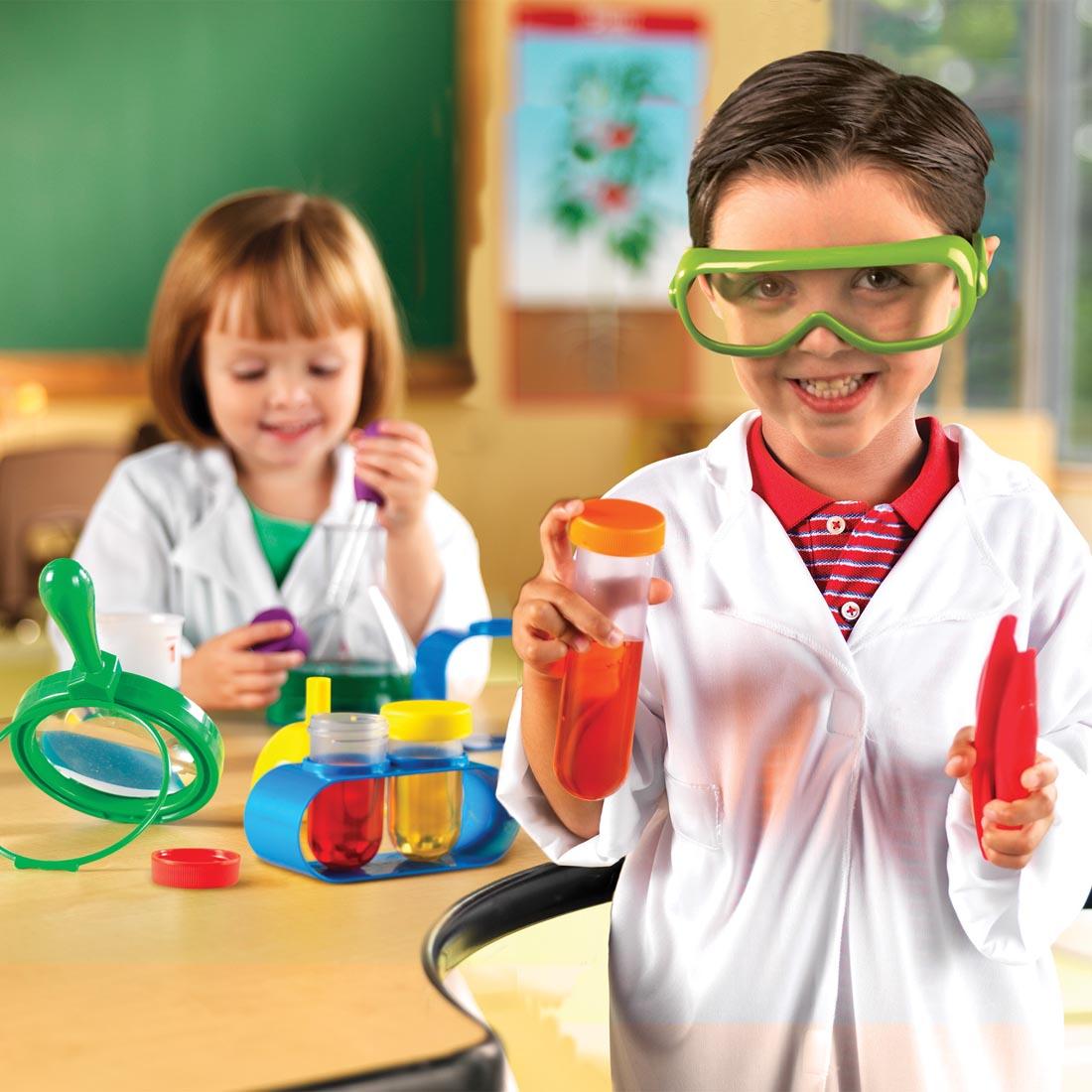 Boy and girl playing with the Primary Science Lab Set by Learning Resources