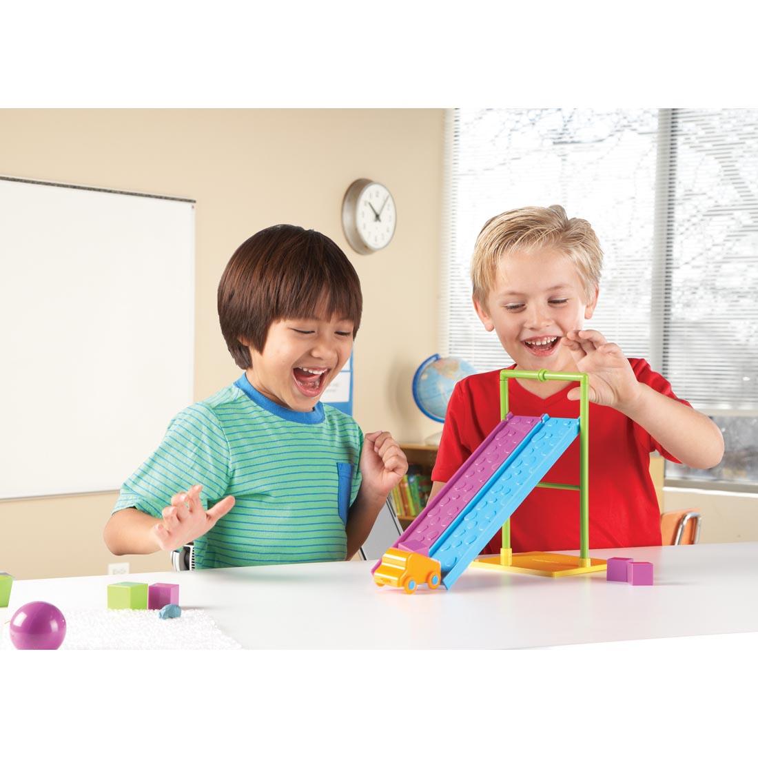 kids experimenting with a car down a ramp, part of the STEM Force & Motion Activity Set