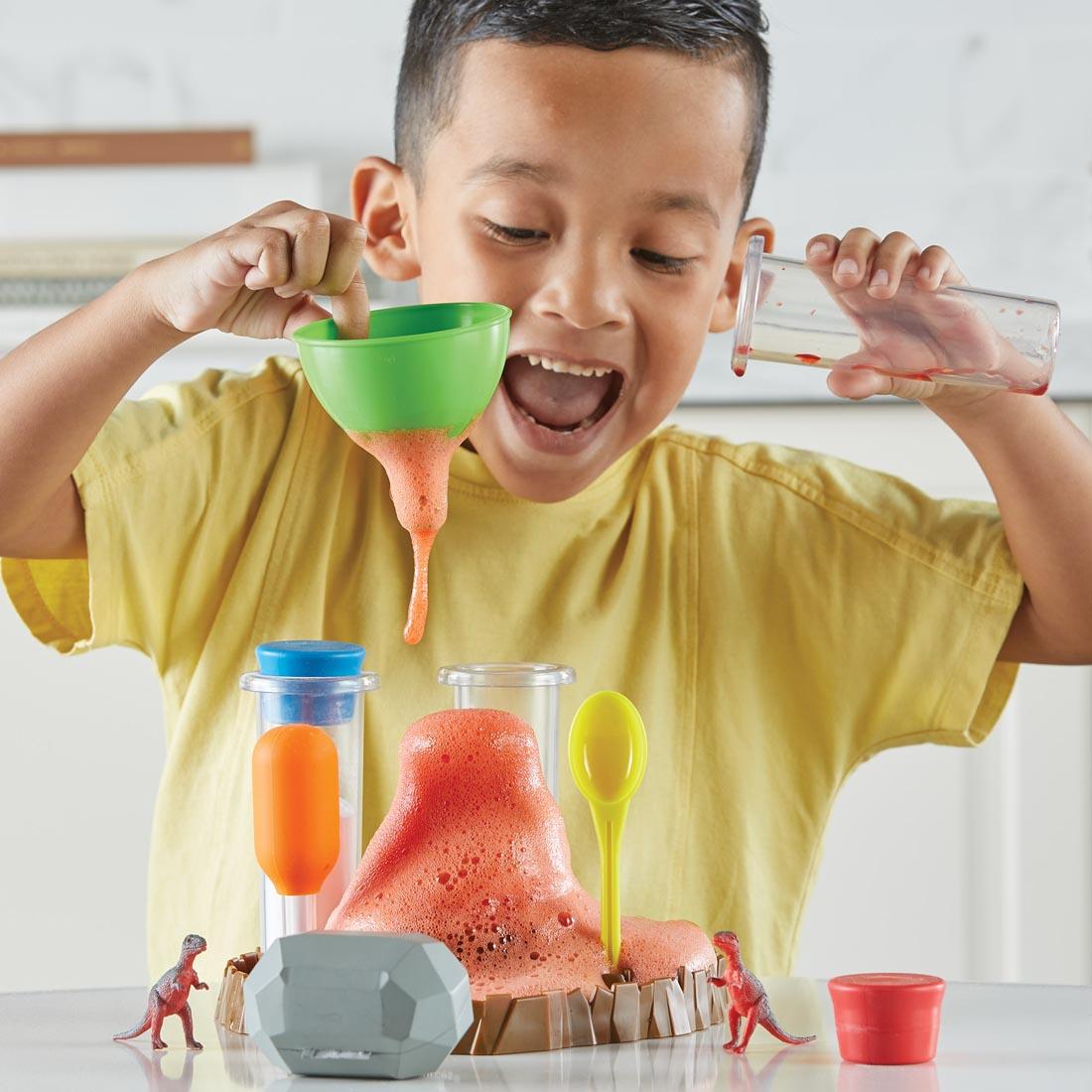 child playing with the Fizzy Volcano Preschool Science Lab set