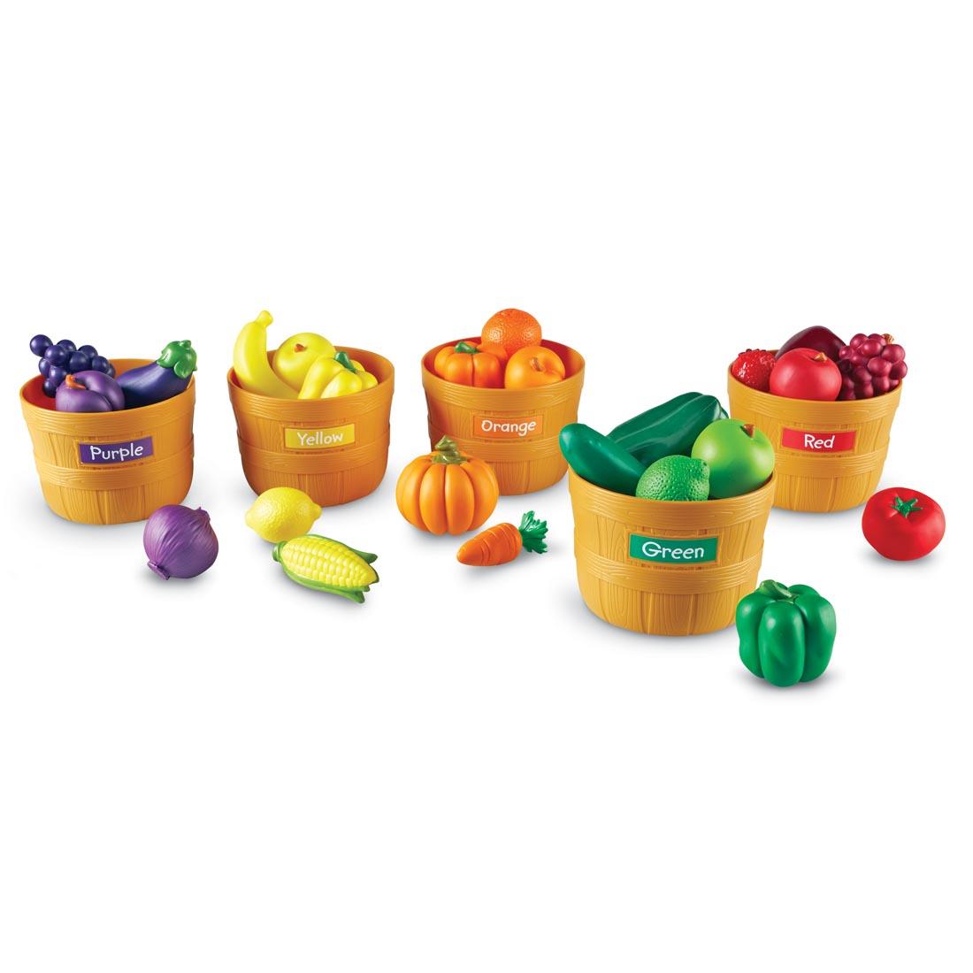 sorting set with colorful plastic fruits and vegetables in baskets