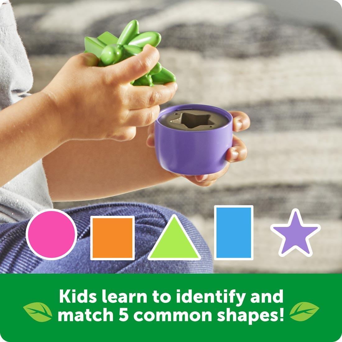 hand holding a flower and pot from the Shape & Color Garden by Learning Resources plus text Kids learn to identify and match 5 common shapes!
