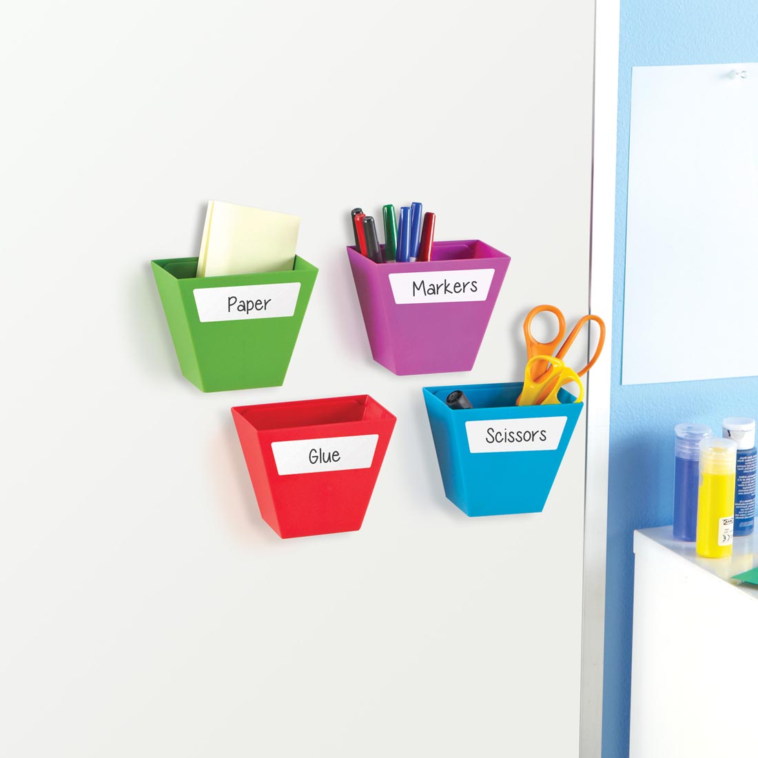 Four Colored Storage Bins hanging from a magnetic whiteboard