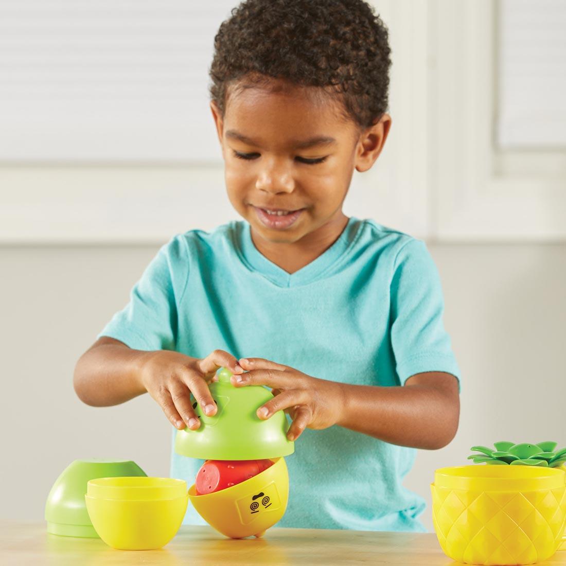 child playing with Big Feelings Nesting Fruit Friends