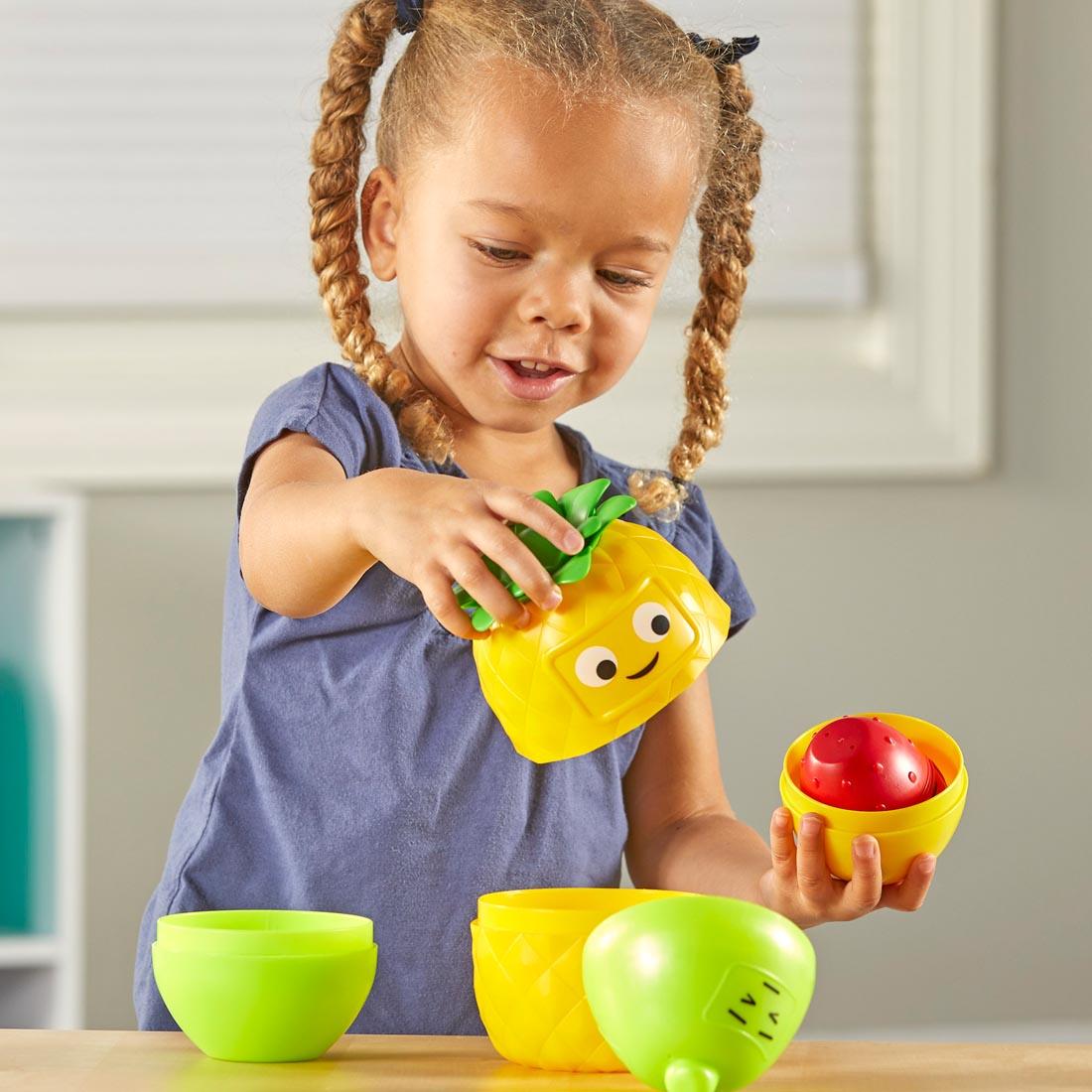 child playing with Big Feelings Nesting Fruit Friends