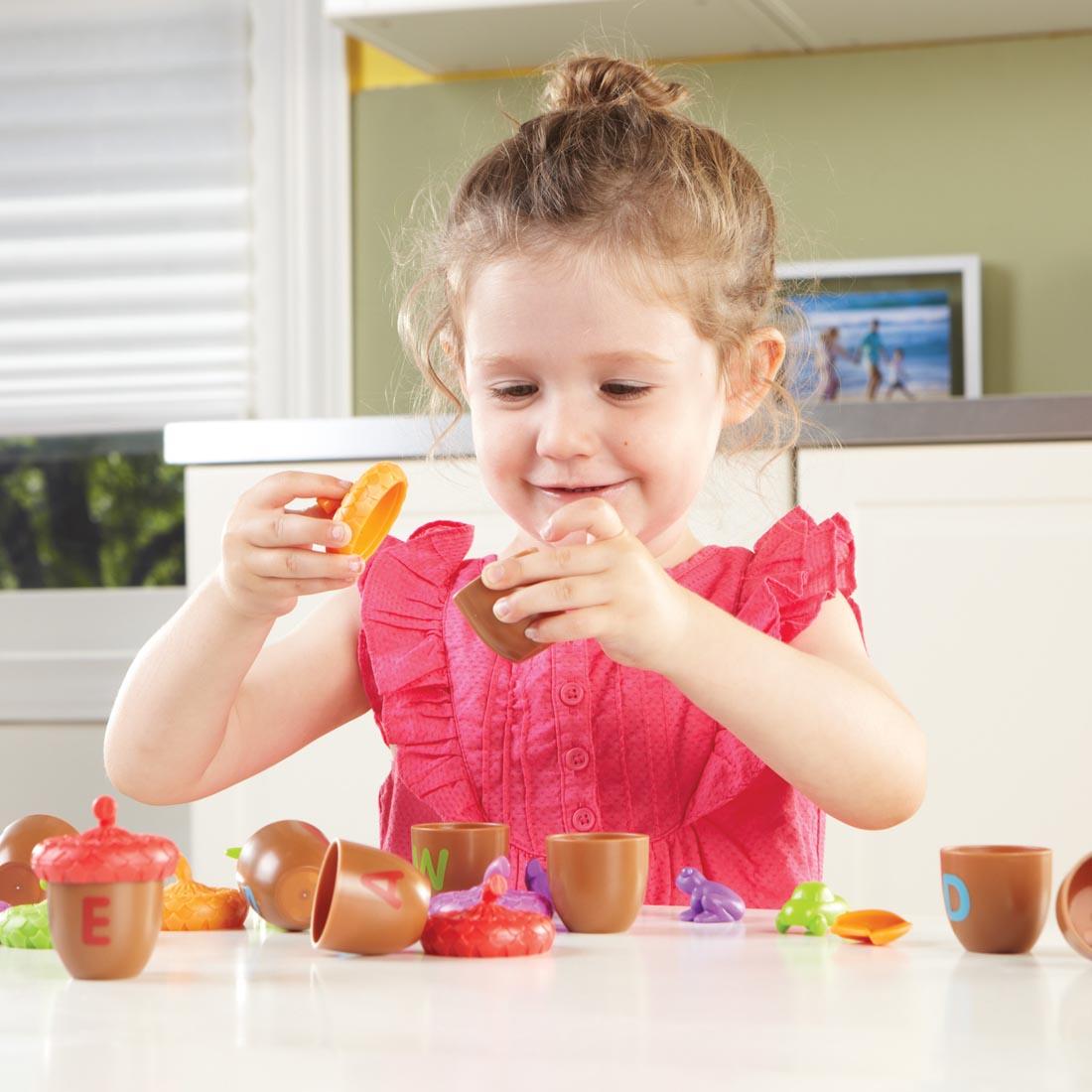 child playing with the Alphabet Acorns Activity Set