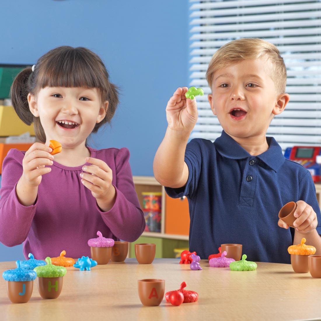 two children playing with the Alphabet Acorns Activity Set