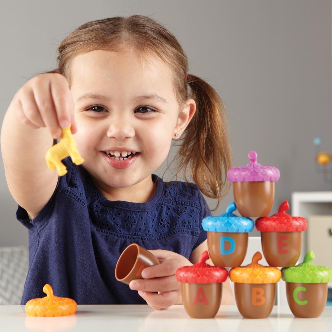 child playing with the Alphabet Acorns Activity Set
