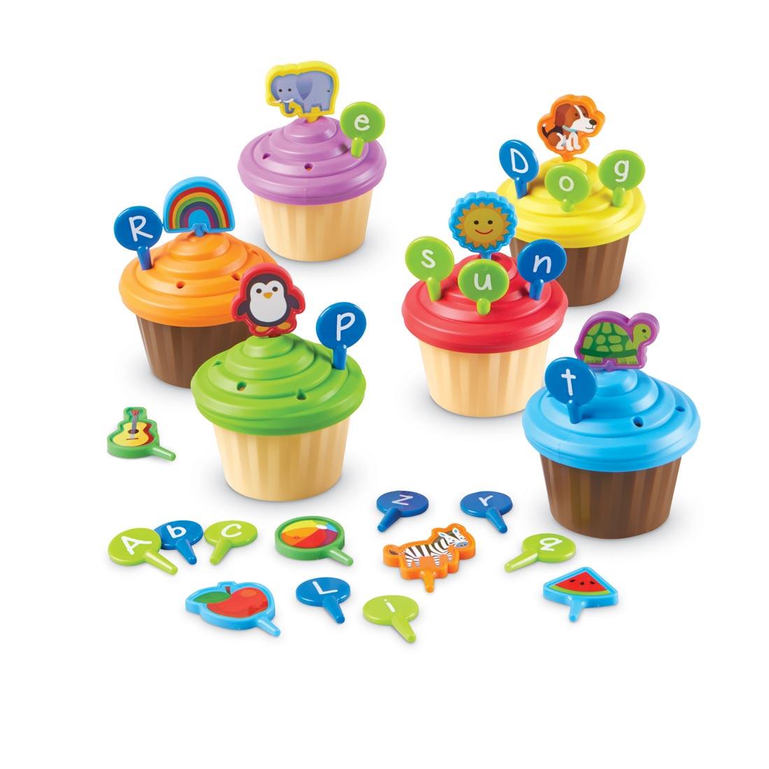 plastic cupcakes have holes in their frosting to accept the letter and picture tiles