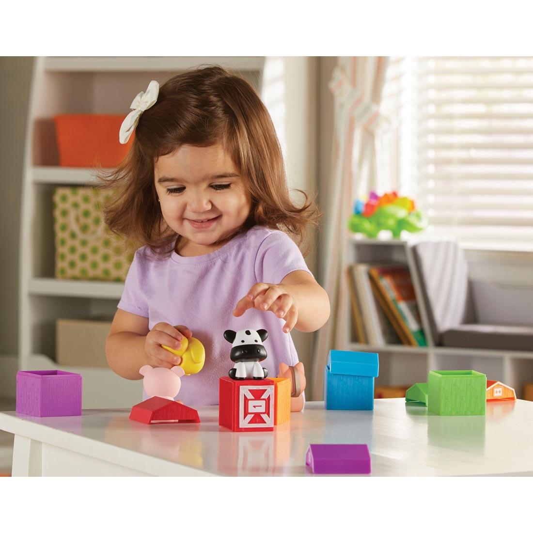 child playing with Peekaboo Learning Farm