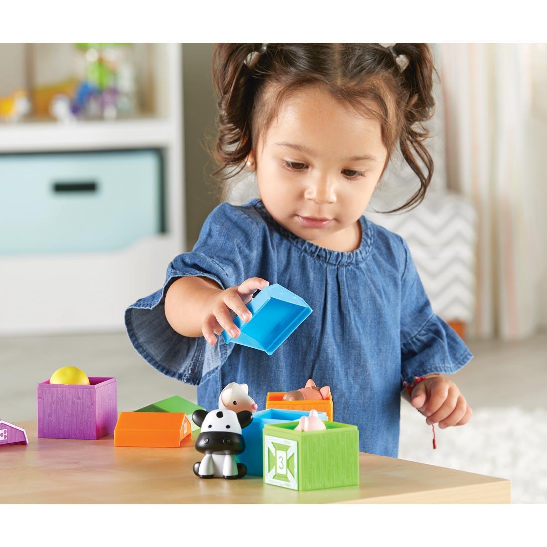 child playing with Peekaboo Learning Farm