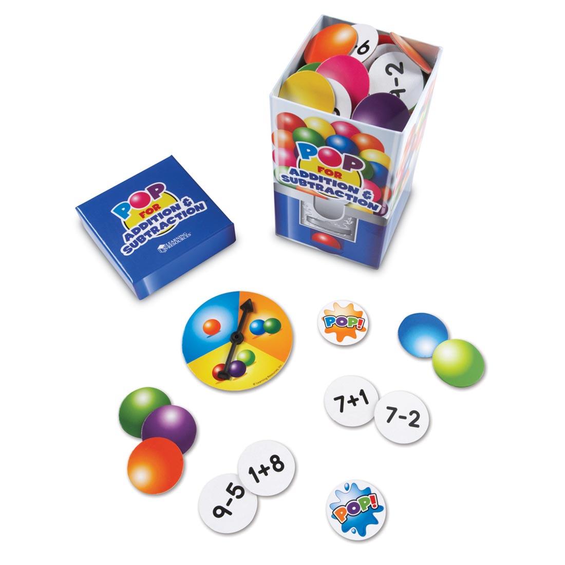 colorful circle cards with simple addition or subtraction equations on the back in a box that looks like a bubble gum dispenser