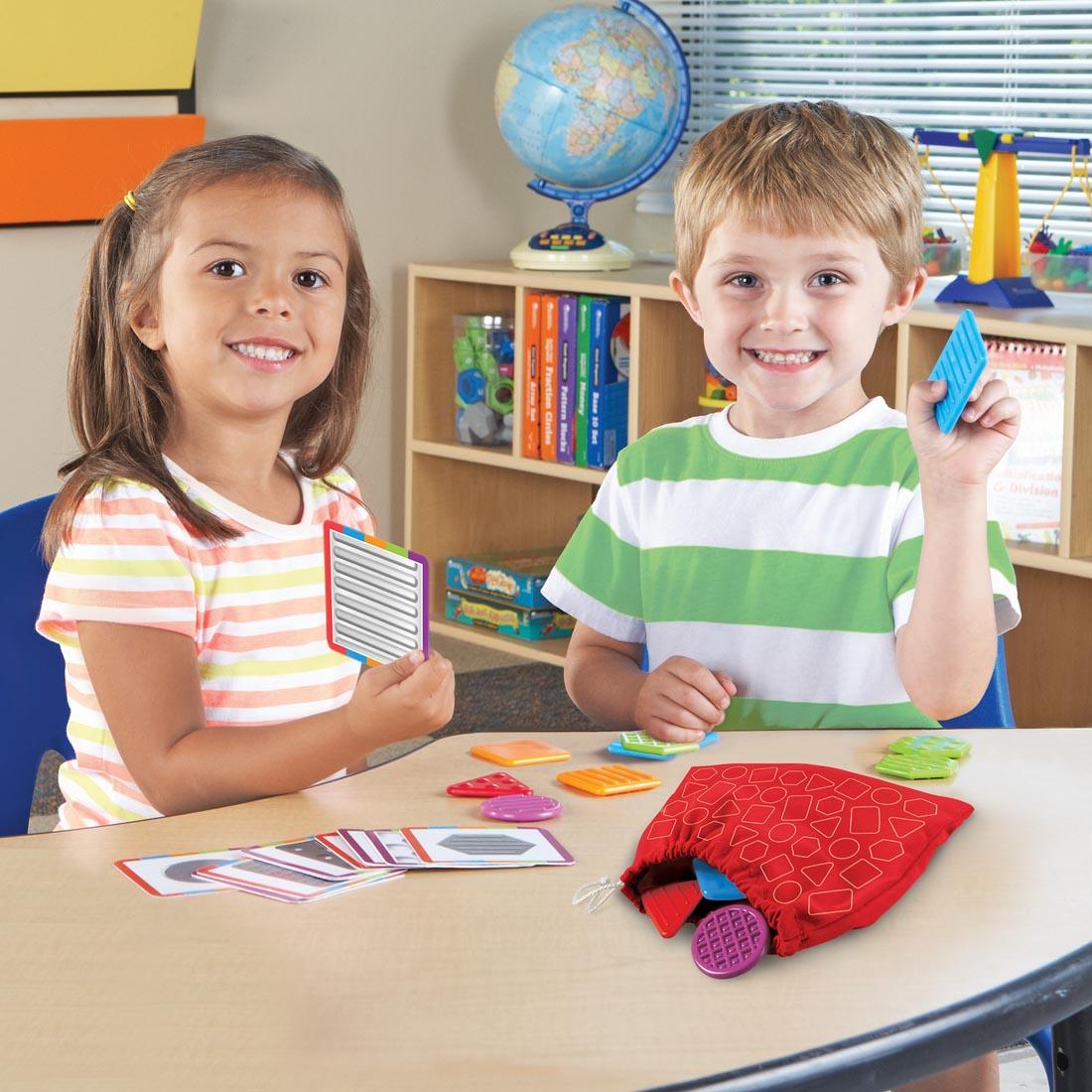 two kids playing with Teaching Tac-Tiles and activity cards