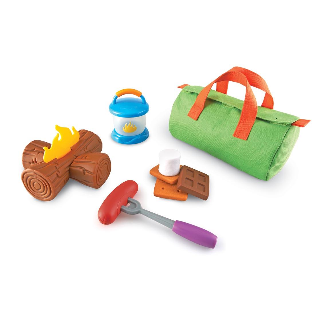 camping toy set with campfire, s'more, hot dog on a roasting stick, lantern and duffle bag