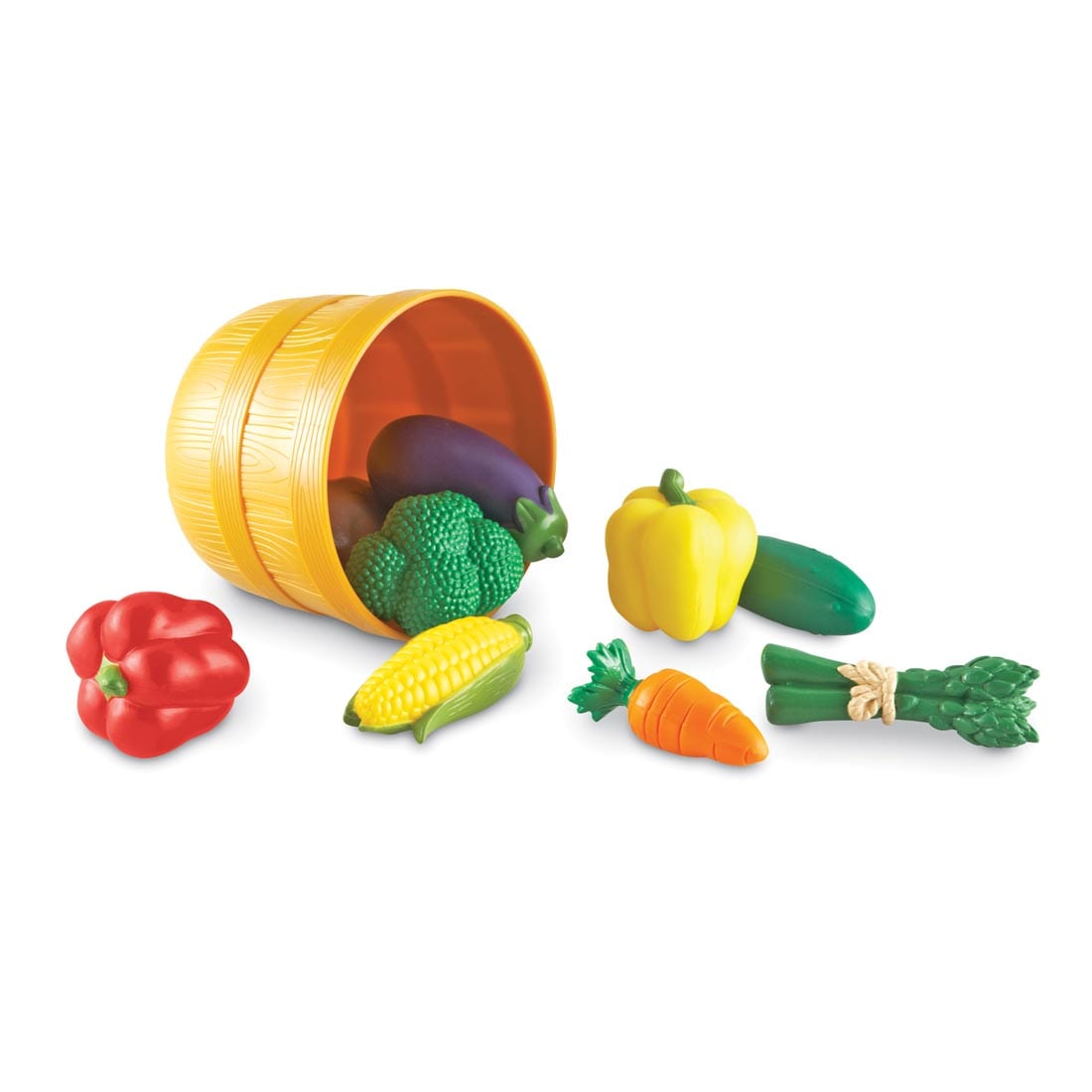 toy bushel basket tipped over to spill out colorful plastic vegetables