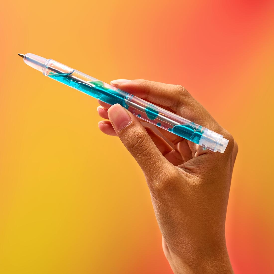 hand holding a Scented Lava Gel Pen by Lifelines, to demonstrate the lava-like motion inside the pen
