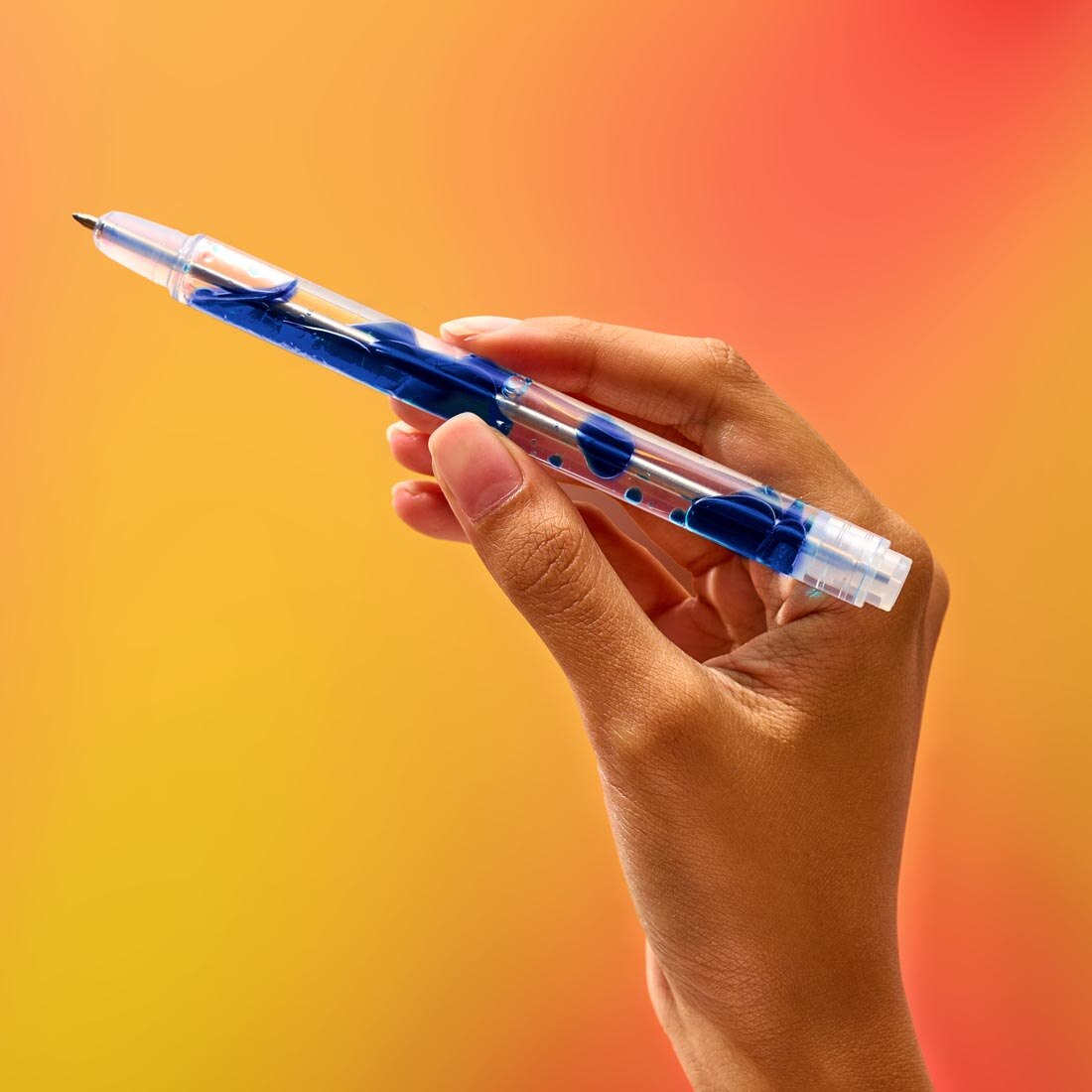 hand holding Scented Lava Gel Pen by Lifelines, to demonstrate the lava-like motion inside the pen