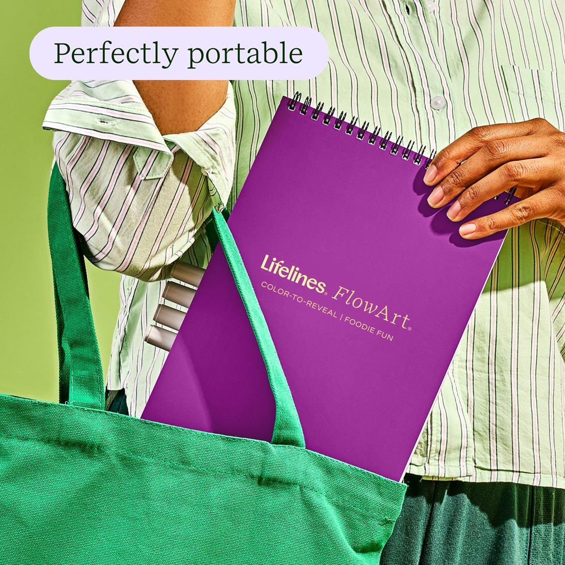 hands putting the FlowArt Color-To-Reveal Foodie Fun by Lifelines into a tote plus text perfectly portable