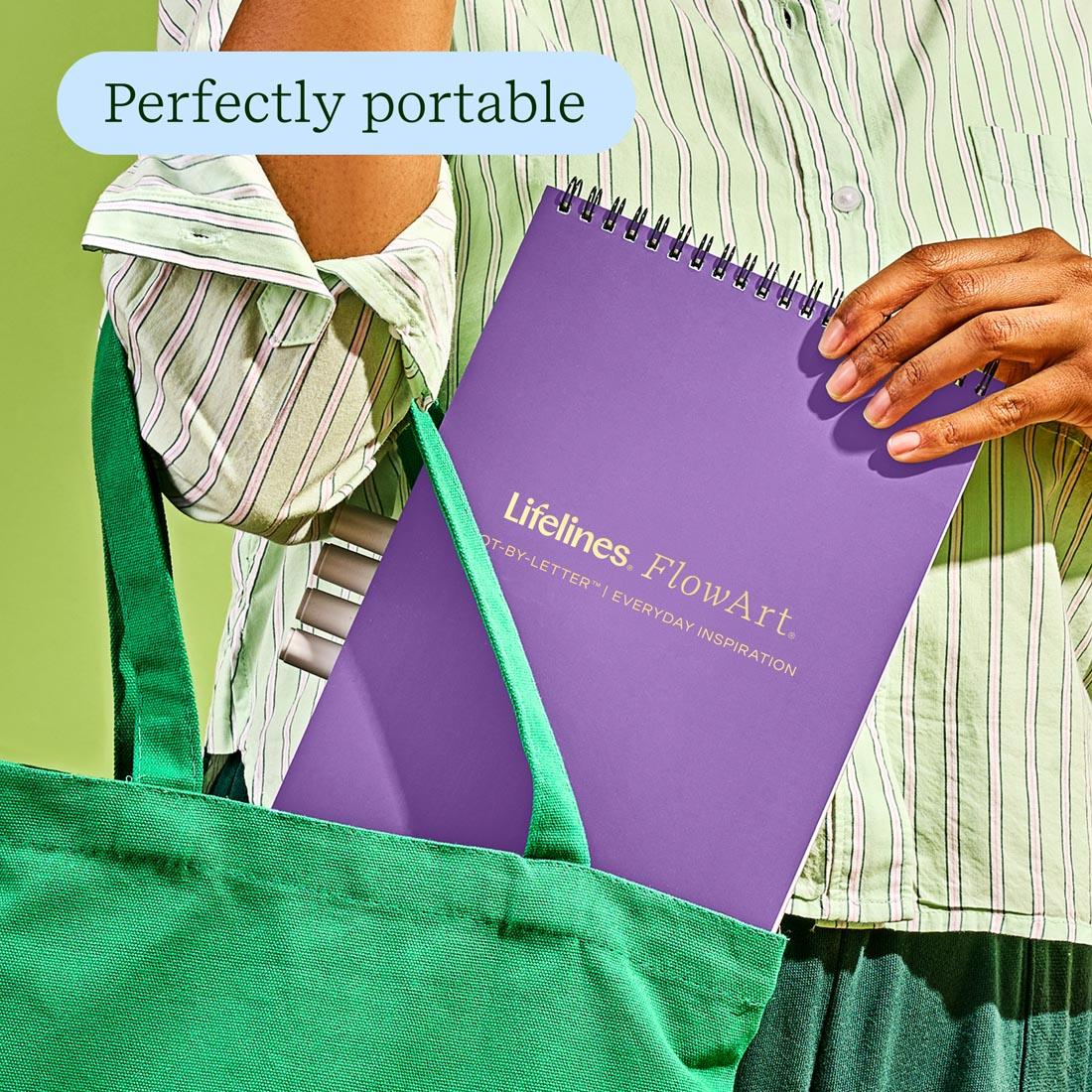 hands putting the FlowArt Dot-By-Letter Everyday Inspirations by Lifelines into a tote plus text perfectly portable