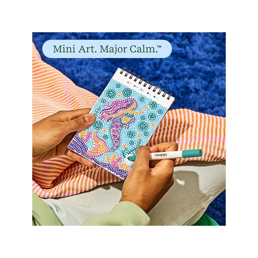 hands working on completing an image in Enchanted Magic Mini Dot-By-Letter FlowArt plus text Mini Art. Major Calm.