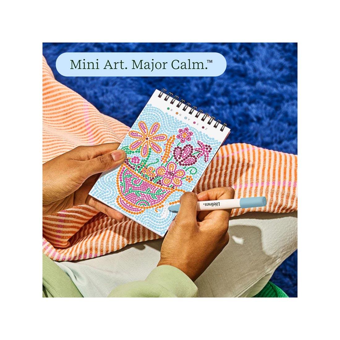 hands working on completing an image in Pretty Petals Mini Dot-By-Letter FlowArt plus text Mini Art. Major Calm.