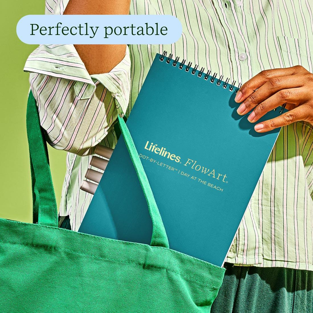 hand putting a Day At The Beach Dot-By-Letter FlowArt by Lifelines into a tote plus text Perfectly portable